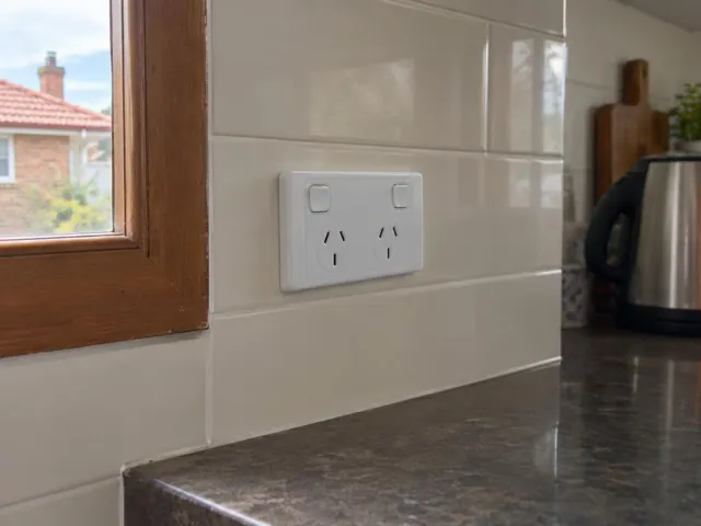 Double power point on a tiled kitchen splashback above a benchtop in Merewether