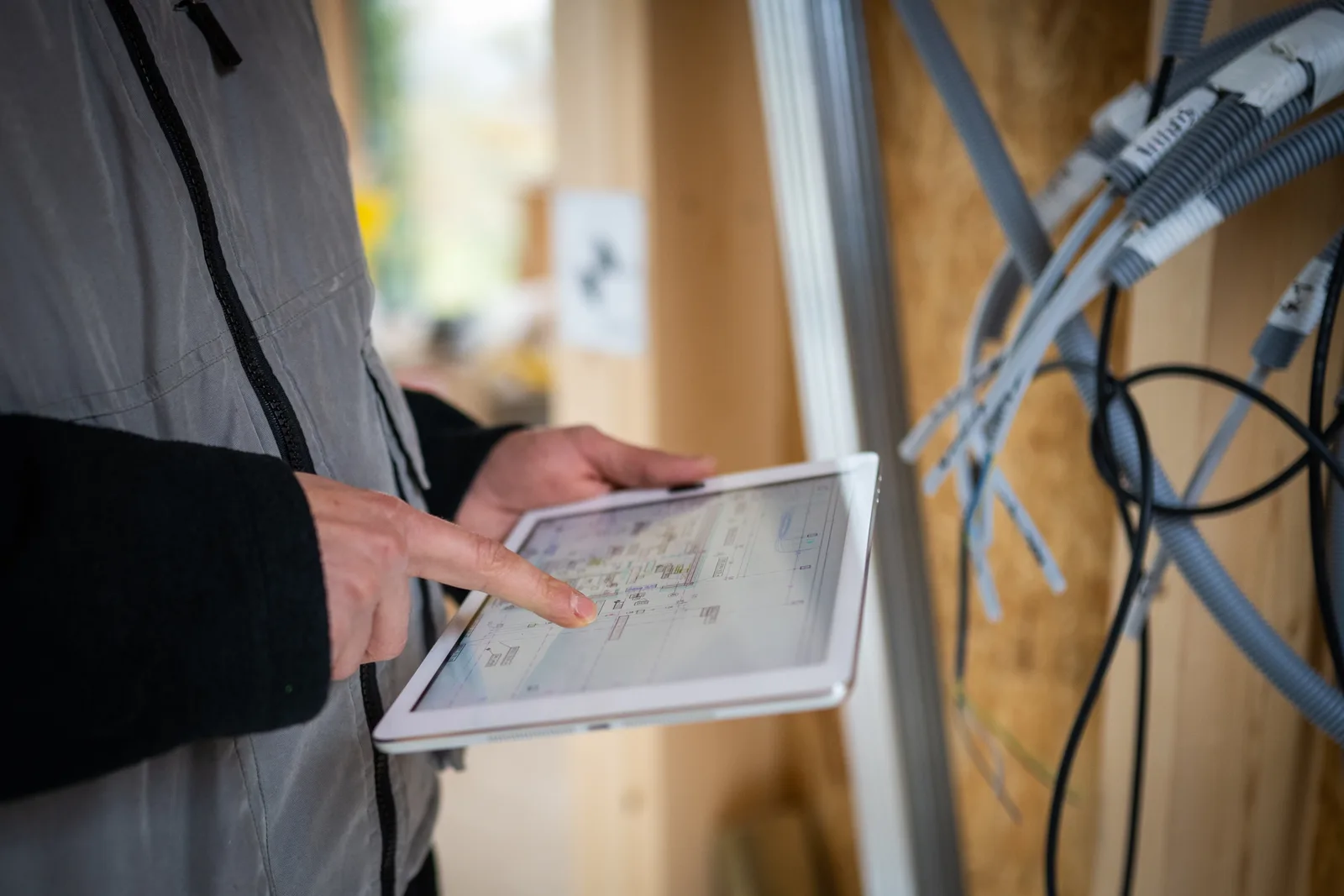 Licensed electrician reviewing a job on site